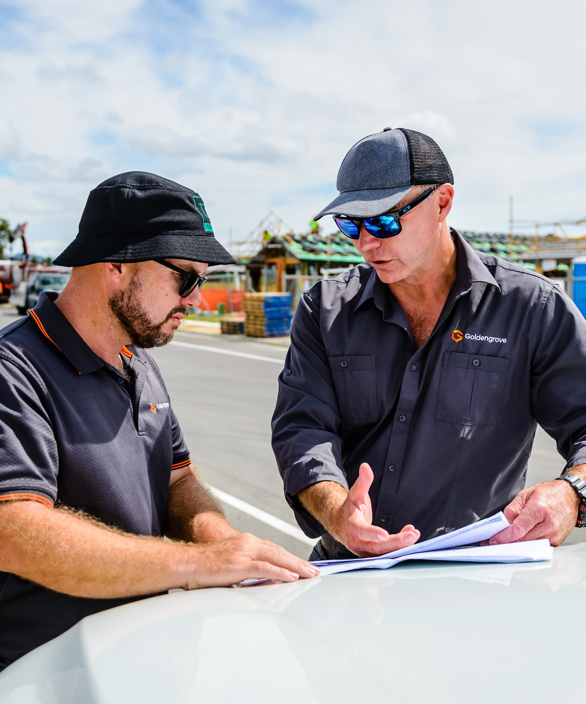 two men going over building plans